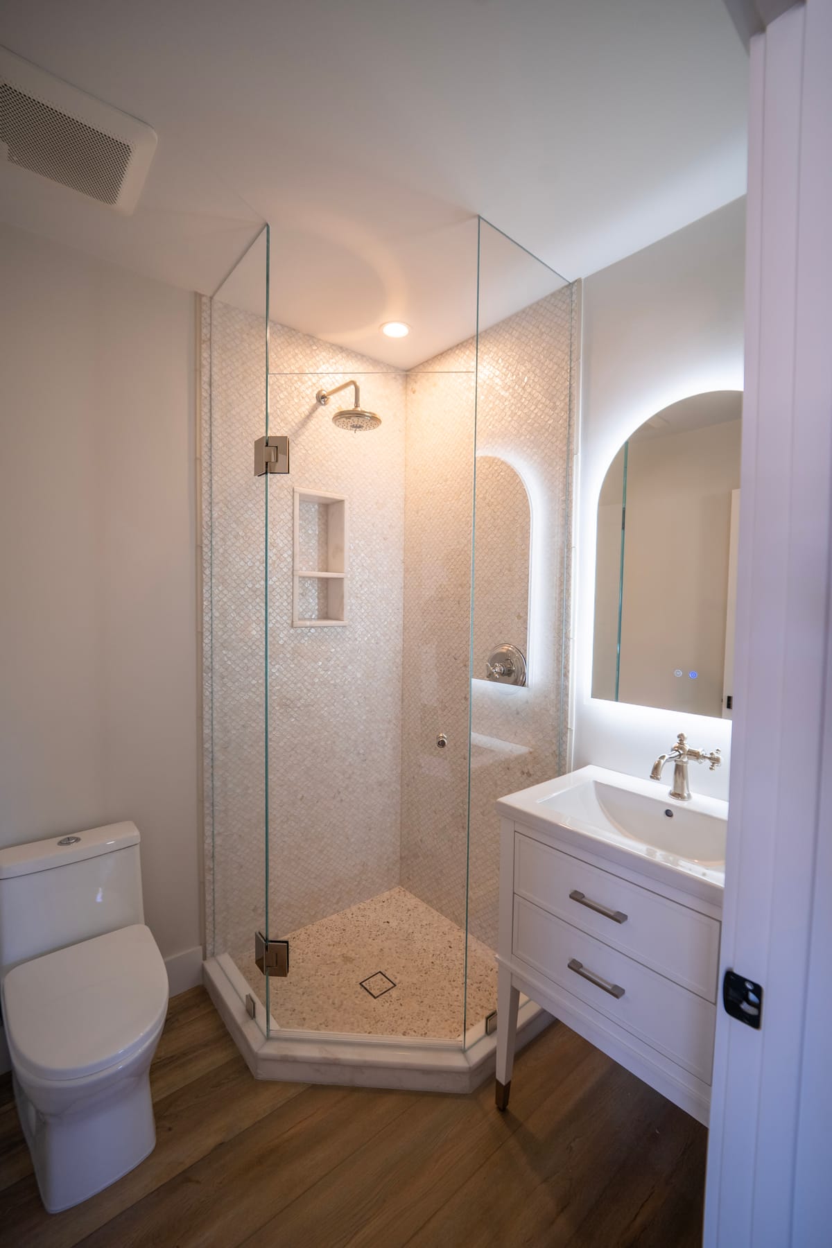 Walk-in glass shower with mosaic tile