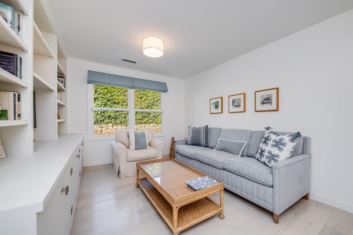 Family room with a gray sofa, armchair and built-in shelving