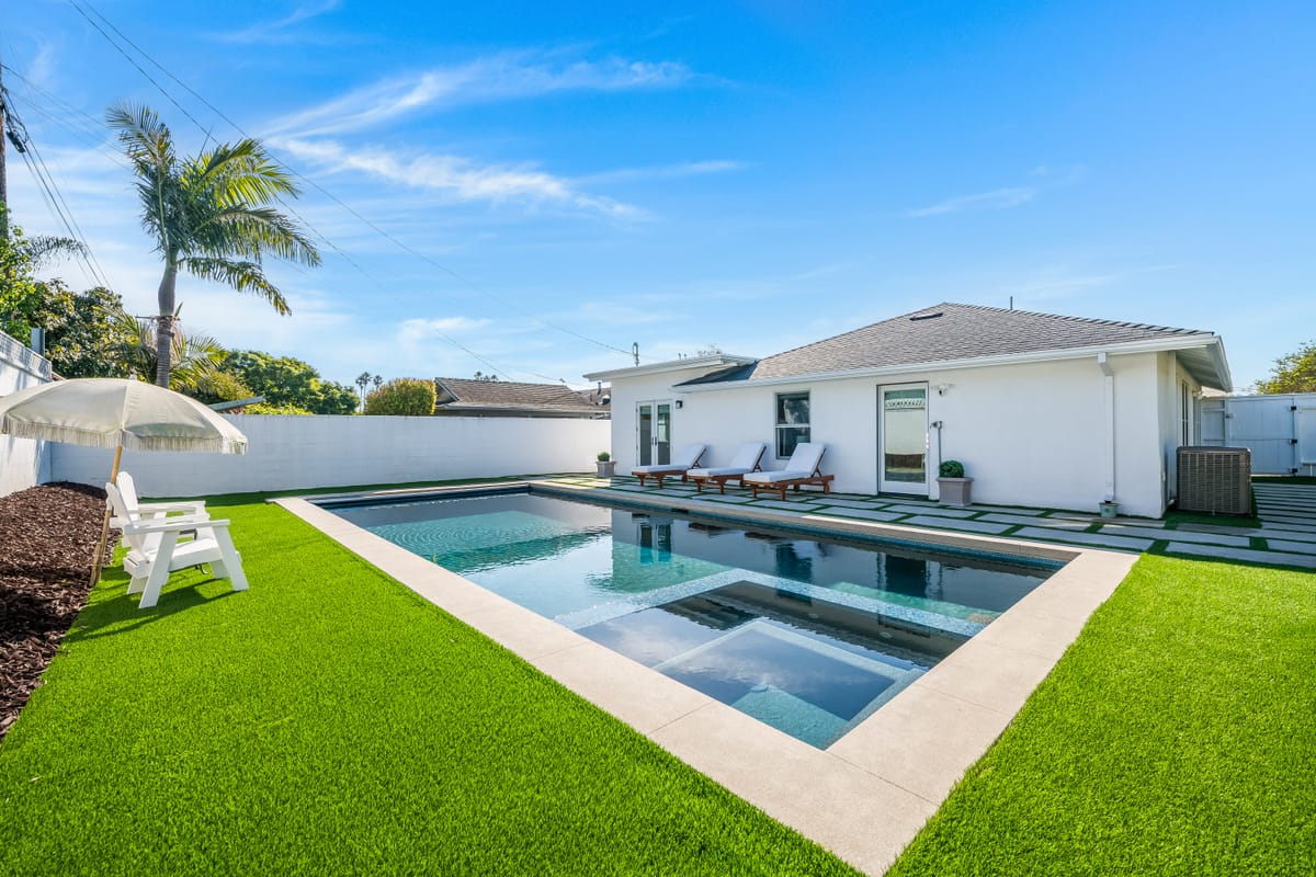 Renovated backyard with pool, spa and turf