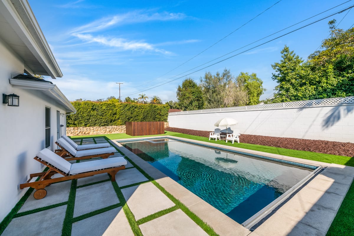 Pool and patio addition with lounge seating in a renovated backyard