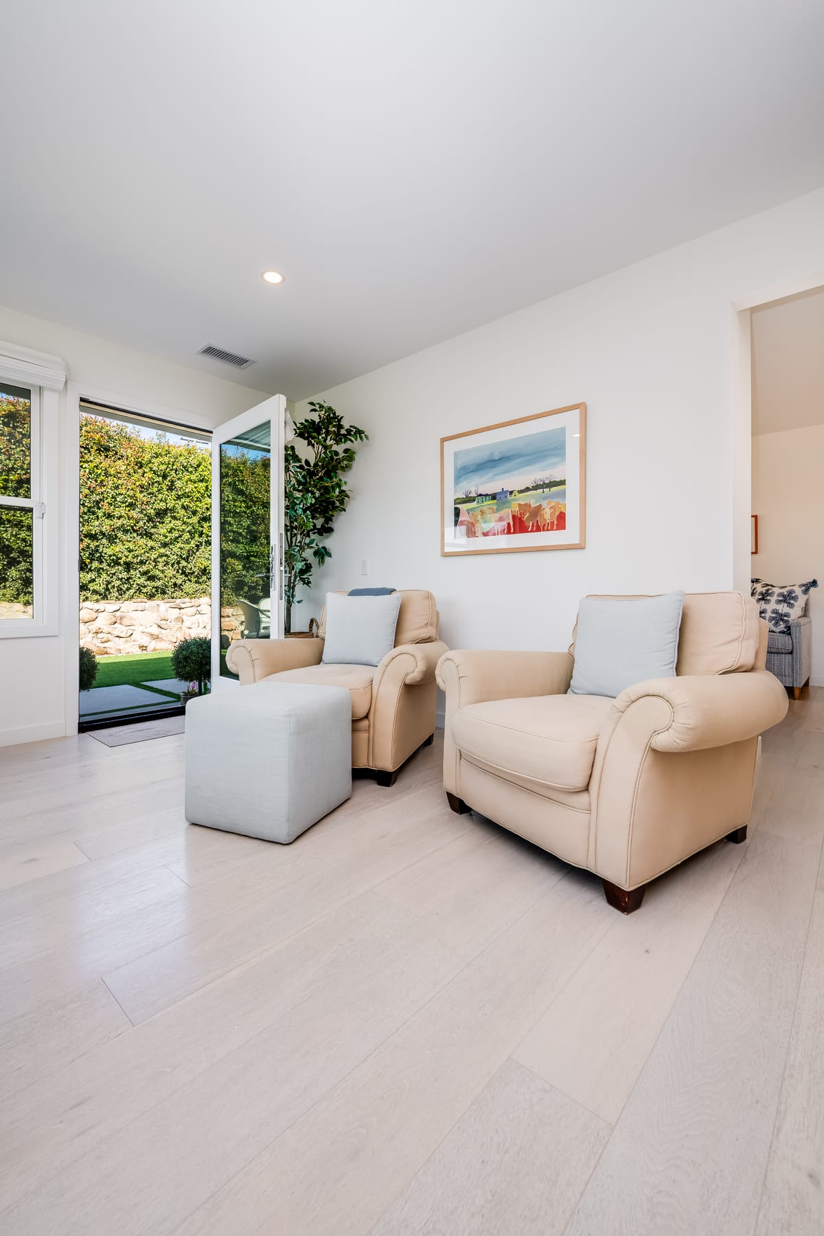 Bright sitting room opening onto a landscaped yard